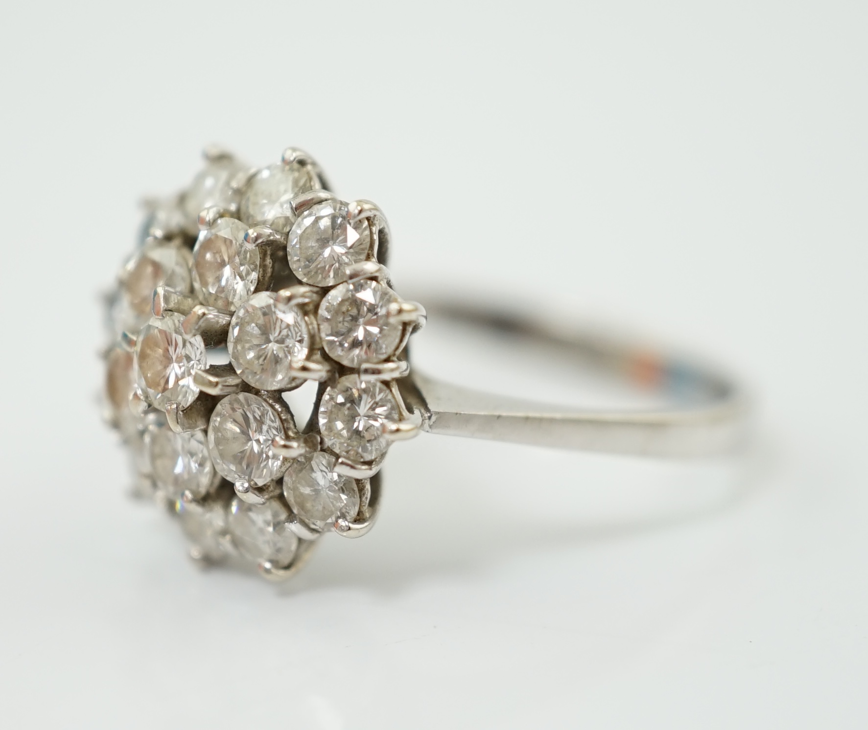 An 18ct white gold and diamond set flower head cluster ring